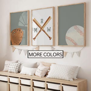May include: Three framed prints with a baseball theme. The first print features a baseball glove, the second print features two crossed baseball bats with the letters "RMW" and the third print features a baseball.