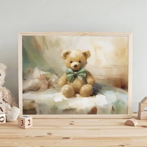 May include: A framed print of a teddy bear with a green bow tie. The bear is light brown and sits on a bed. The artwork has a soft, painterly style with a light color palette. Wooden blocks and a teddy bear are on the table.
