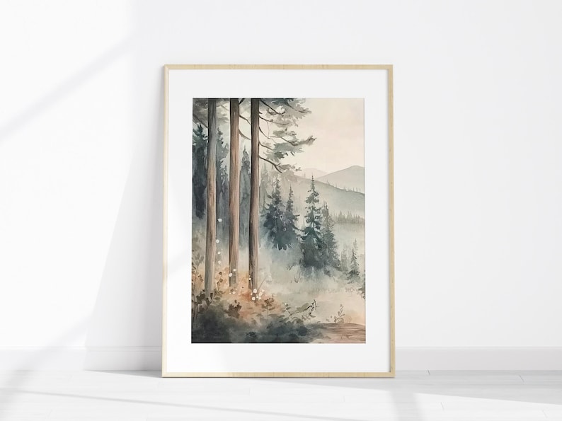 May include: A framed watercolour painting depicting a forest landscape. The artwork features tall trees in the foreground, with a misty forest and mountains in the distance. The colour scheme is soft, using muted greens, browns, and blues.