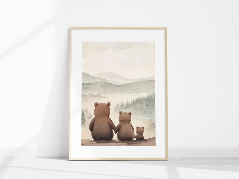 May include: Framed watercolour print depicting a bear family looking at a misty mountain scene. The bears, in shades of brown, are seen from behind. The artwork is in a light wood frame, evoking a sense of family and nature.