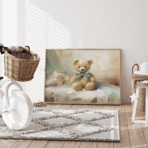 May include: A framed print of a teddy bear with a green bow tie. The artwork has a soft, painterly style with muted colors. The print is displayed in a child's room with a white tricycle and a woven basket.