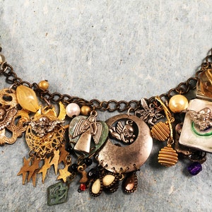 May include: A charm bracelet with a variety of charms, including angels, stars, hearts, and a crescent moon. The bracelet is made of metal and has a silver tone finish.