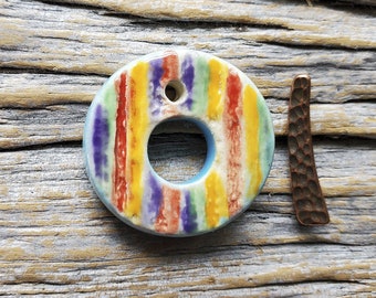 This Colorful striped toggle clasp, commercial Tierra Cast bar, is handmade by Mary Harding