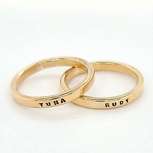 May include: Two gold rings with the names "TUNA" and "RUDY" engraved on them.