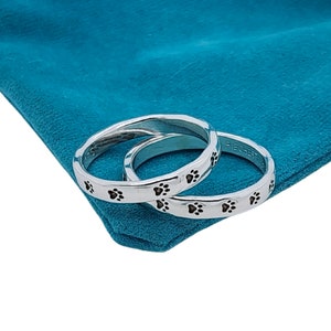 silver rings with cat paws around the band