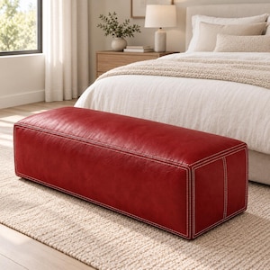 May include: A rectangular, low-profile bench upholstered in deep red leather. The piece features prominent, light-colored contrast stitching along all edges and seams, creating a defined, structured appearance with a smooth, matte finish.