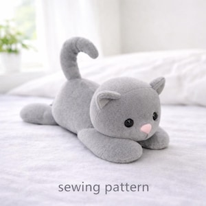 Könnte beinhalten: Ein Set aus drei Keramikbechern mit gesprenkelter, matter Oberfläche. Die Becher sind in Creme-, Hellgrau- und Dunkelgrautönen gehalten. Jeder Becher hat ein schlichtes, minimalistisches Design.