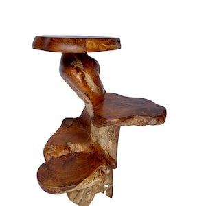 May include: A wooden shelf with three tiers, each with a unique shape and size. The shelf is made of natural wood with a rich brown color and a rustic finish.