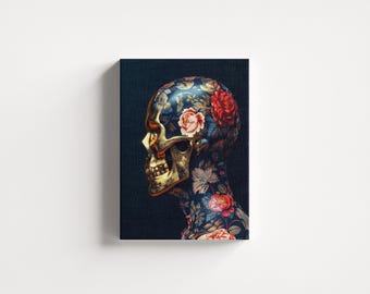 May include: Canvas art print featuring a side profile of a skull with a gold-colored face and a floral pattern on the head and neck. The flowers are red, pink, and white against a dark blue background.