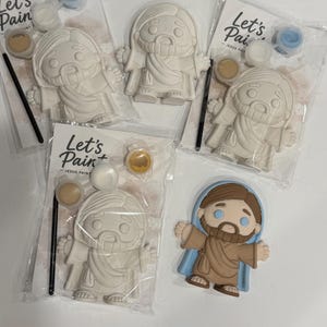 May include: Paint-your-own Jesus craft kits. Each kit includes a plaster figure of Jesus, paint pots, and a paintbrush. The kits are packaged in clear plastic bags with the text "Let's Paint - Jesus Paint". One finished Jesus figure is also shown.