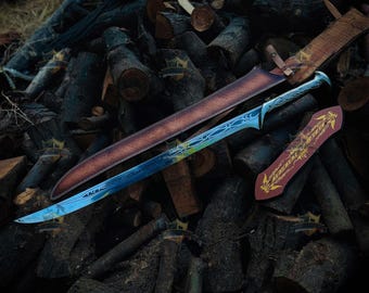 May include: A long, curved sword with a metallic blade featuring intricate blue and silver etched patterns. The sword is accompanied by a brown leather scabbard and a separate, smaller red and gold decorative piece with a bird emblem.