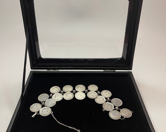 A wonderful silver coin bracelet constructed with silver 50 cent coins from Alfonso XIII Spain. In glass display case.