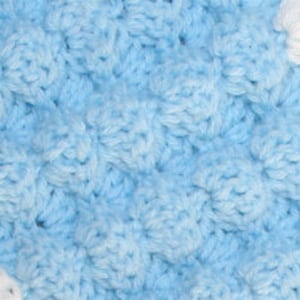 May include: A blue and white crocheted blanket with a textured pattern. The blanket is made with soft yarn and has a delicate, hand-crafted look.