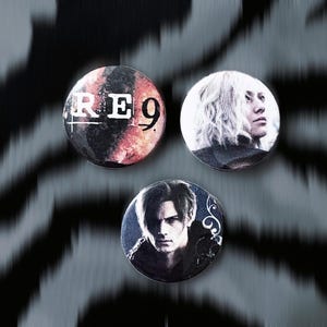 May include: Three round pinback buttons with images of people and the text "RE9". The buttons have a black and white background with a zebra stripe pattern. The buttons are in shades of black, white, red, and blue.
