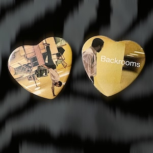 May include: Two heart-shaped pins featuring imagery from the Backrooms. The left pin shows a person in a light shirt and dark pants standing on a ceiling in a yellow room. The right pin shows a person in a light shirt with the text Backrooms.