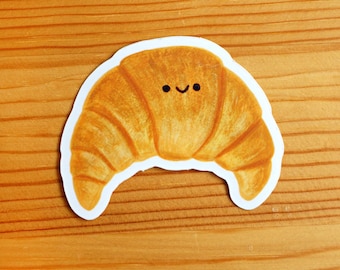 Adhesivo de vinilo con diseño de croissant.