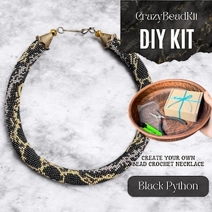 May include: DIY kit to create a black and gold bead crochet necklace. The kit includes beads, thread, and instructions. The finished necklace is called "Black Python".