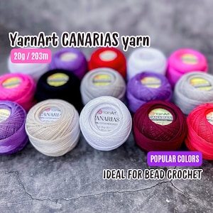 Può includere: Una collezione di gomitoli di filato di cotone mercerizzato YarnArt Canarias da 20 grammi in vari colori, tra cui bianco, rosso, rosa, viola e nero. Il filato è ideale per l'uncinetto con perline.