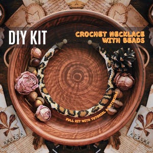 May include: DIY kit for a crochet necklace with beads. The necklace is brown, black, and white with a leopard print pattern. The kit includes all materials and a tutorial.