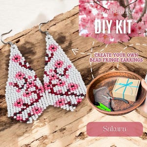 May include: White and pink beaded fringe earrings with a floral design. The earrings are triangular and hang from silver hooks. The image also shows a DIY kit with the text "Create Your Own Bead Fringe Earrings" and the word "Sakura".