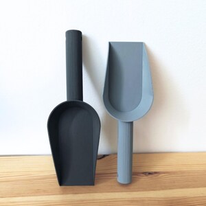 Two repotting scoops in different sizes on white background
