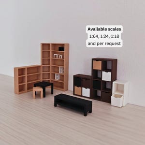 May include: Miniature wooden furniture set including bookshelves, a coffee table, a bench, and cube storage units. The furniture is in various colors, including natural wood, black, and white. Text on the image states "Available scales 1:64, 1:24, 1:18 and per request."