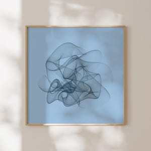 May include: Abstract artwork in a gold frame, showcasing a dark blue, net-like pattern on a light blue backdrop. The square print presents a flowing design, creating a modern aesthetic. The artwork is mounted on a neutral-toned wall.