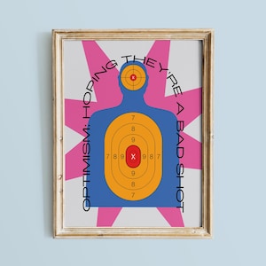 May include: A blue silhouette of a person with a target overlayed on the chest. The target has concentric circles in yellow and orange with a red bullseye. The text around the target reads "OPTIMISM: HOPING THEY'RE A BAD SHOT".