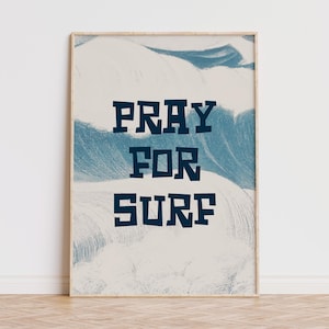 May include: A framed print with a blue and white abstract design and the text "Pray for Surf" in dark blue.