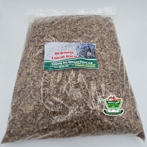 May include: A clear plastic bag filled with brown organic local rice. The bag has a label that reads "Organic Local Rice" and "Tripple Joy African Store LLC".