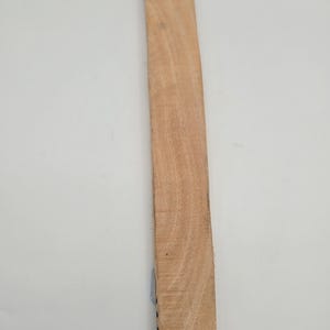 May include: A rectangular, unfinished wooden plank with visible wood grain. The plank is a light brown color and appears to be freshly cut. The image is taken against a white background. The product is from the Tripple Joy African Store.