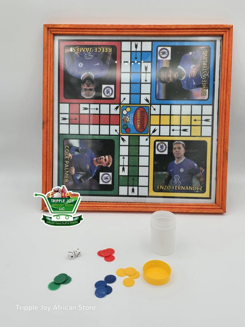 May include: A wooden framed board game with a colorful grid and images of soccer players. The game is called "Supreme Ludo Game". There are also dice, counters, and a container for the counters.