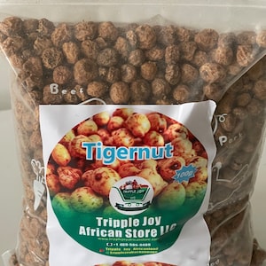 May include: A clear plastic bag filled with tigernuts. A label on the bag reads "Tigernut" and "Tripple Joy African Store LLC". The label also shows a picture of tigernuts and the weight of the contents, 100g.