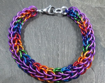 May include: A rainbow colored metal chain bracelet with a silver clasp.