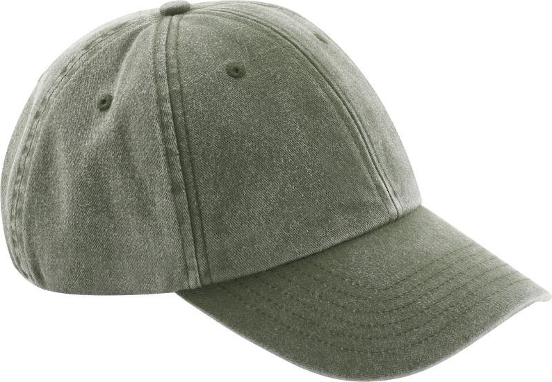 Op de afbeelding: Een effen olijfgroene baseballpet met een gewassen, textuurrijke stoffen afwerking. De pet heeft een constructie van zes panelen met gestikte oogjes op elk paneel, een gebogen klep met horizontale stiksels en een met stof beklede knoop.