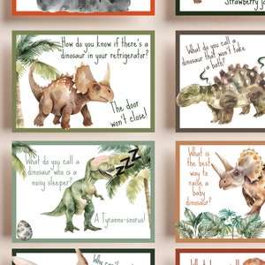 May include: A set of 8 illustrated cards with dinosaur puns. Each card features a different dinosaur with a watercolor background and a punny question and answer. The cards are perfect for a fun game or activity.
