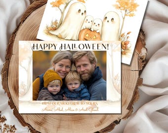 May include: A Halloween greeting card with a watercolor illustration of ghosts and a pumpkin. The card features a photo of a family of four with the text "Happy Halloween! From our boo-crew to yours, Anna, Abel, Alice & Avel Ghoul."
