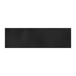May include: A solid black rectangular object. The object is a dark, matte black color. The shape is a long rectangle, with a smooth, flat surface. The object is likely a piece of furniture or a decorative element.