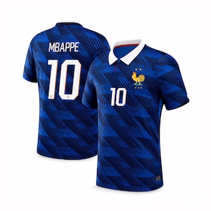 Puede incluir: Una camiseta de fútbol azul con un patrón de rayas diagonales azul oscuro, cuello tipo polo blanco y el número 10 en la parte delantera y trasera. La espalda muestra el nombre MBAPPE sobre el número 10, y el frente tiene un emblema de gallo y dos estrellas.