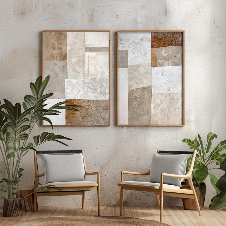 May include: Two abstract paintings in beige, brown, and white tones are displayed on a wall above two wooden chairs with light gray cushions. The chairs are positioned on a light brown rug.