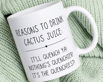 May include: White ceramic mug with black text that reads "Reasons to drink cactus juice: It'll quench ya! Nothing's quenchier! It's the quenchiest!" The mug is sitting on a light green knitted blanket.