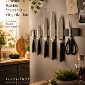 May include: A selection of kitchen knives with black handles and silver blades, mounted on a magnetic strip. The knives are displayed on a grey surface, with text that reads "A Beautiful Kitchen Starts with Organization."