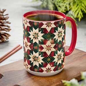 May include: A ceramic mug with a red handle and interior, featuring a repeating geometric star pattern in shades of dark green, deep red, and cream. The mug is filled with dark coffee and displays a vibrant, multi-pointed star design.