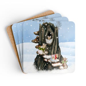 May include: Set of four square coasters. Each coaster features a whimsical illustration of mice in a snowy scene, gathered around a tree stump. The background is a light blue with falling snow. The coasters have a cork backing.