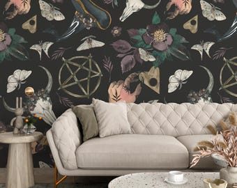 May include: A black and white wallpaper with a repeating pattern of flowers, butterflies, skulls, hands, and pentagrams. The wallpaper is shown in a living room setting with a white sofa and a coffee table.