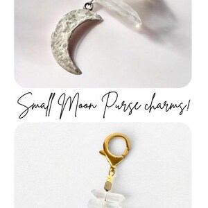 May include: Small moon purse charms. The charms feature a crescent moon pendant and clear crystal accents. One charm has a silver-colored moon, and the other has a gold-colored moon. Both have a clasp for easy attachment.