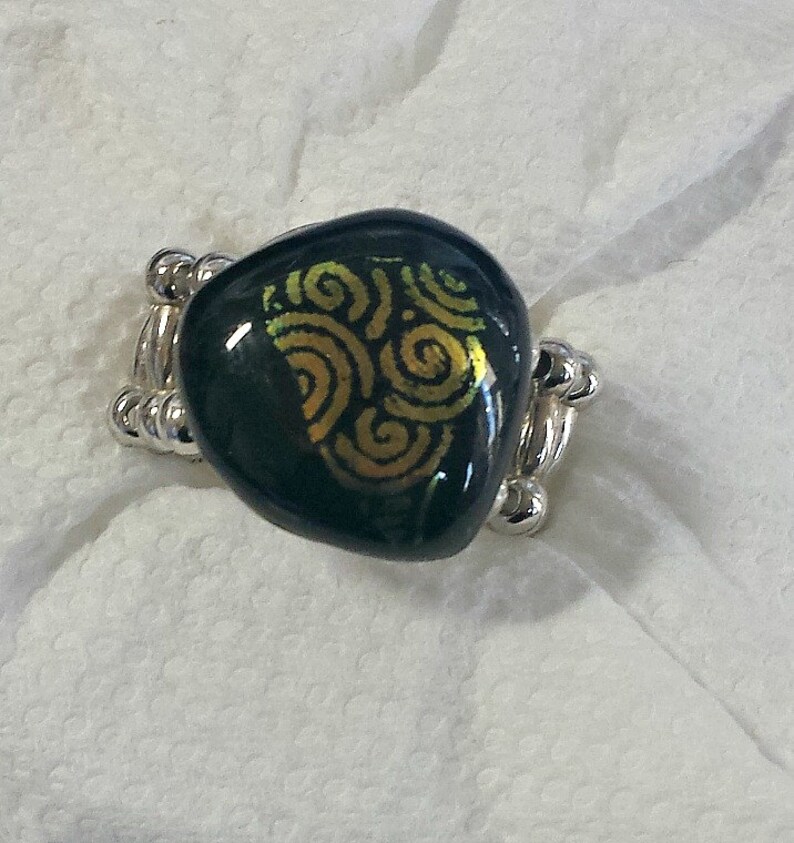 Fused glass ring  fused dichroic swirls and a black image 0
