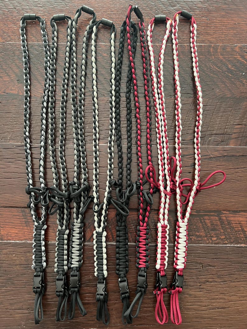 Puede incluir: Ocho cordones trenzados en combinaciones de colores negro, blanco y rojo. Cada cord&oacute;n tiene un clip de pl&aacute;stico negro en el extremo.