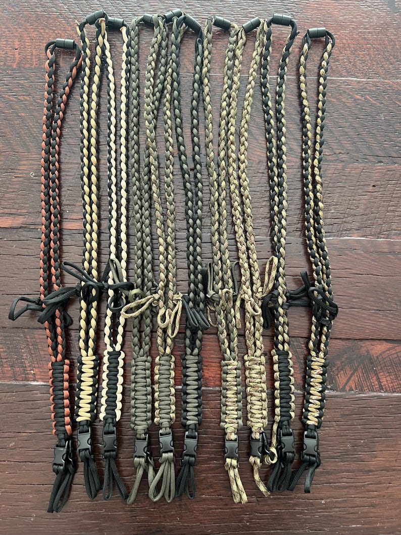 Puede incluir: Diez cordones de paracord diferentes con clips negros. Los cordones est&aacute;n hechos con diferentes combinaciones de colores de paracord negro, marr&oacute;n, beige y verde.