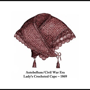 May include: A vintage crocheted cape with a scalloped edge and tassels. The cape is a deep burgundy color and is labeled "Antebellum/Civil War Era Lady's Crocheted Cape ~ 1869".